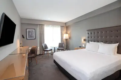 a hotel room with a bed and a desk at Sandman Hotel Hamilton in Hamilton