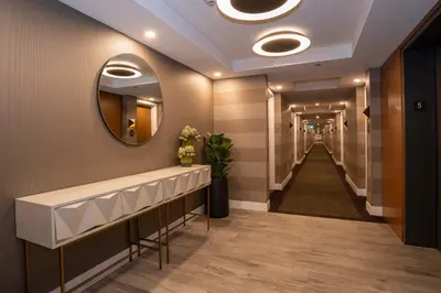 a hallway with a mirror and a long corridor at Sandman Hotel Hamilton in Hamilton