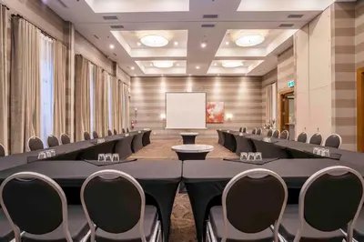 a conference room with rows of chairs and a whiteboard at Sandman Hotel Hamilton in Hamilton