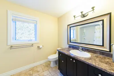 a bathroom with a sink and a toilet and a mirror at HB Guest Home 4 in Waterloo