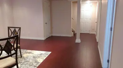 an empty living room with wood floors and white walls at HB Guest Home 5 in Waterloo