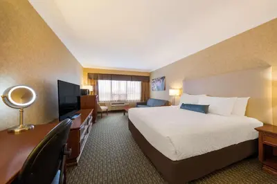 a hotel room with a bed and a desk at Best Western Voyageur Place Hotel in Newmarket