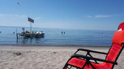 a group of people in a boat on the beach at SunPort Beach Resort in Balm Beach
