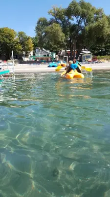 a person riding on a raft in the water at SunPort Beach Resort in Balm Beach