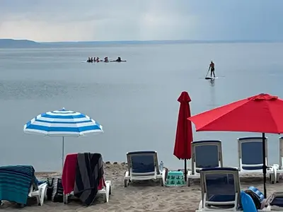 a group of chairs and umbrellas on a beach at SunPort Beach Resort in Balm Beach