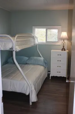 a bedroom with a bunk bed and a white dresser at SunPort Beach Resort in Balm Beach