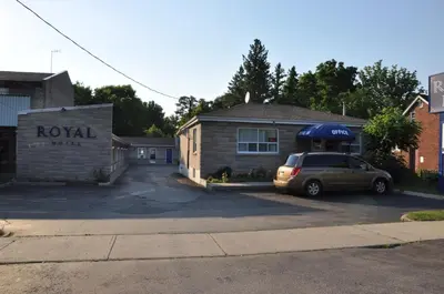 a car parked in a parking lot in front of a house at Royal Inn in Burlington