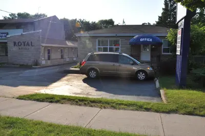 a car parked in a parking lot in front of a building at Royal Inn in Burlington