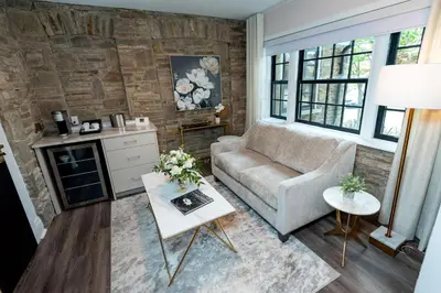 a living room with a couch and a table at The Glenerin Inn in Mississauga