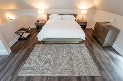 a bedroom with a bed and two night stands at The Glenerin Inn in Mississauga