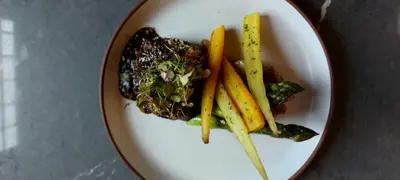 a plate of food with vegetables on a table at The Glenerin Inn in Mississauga