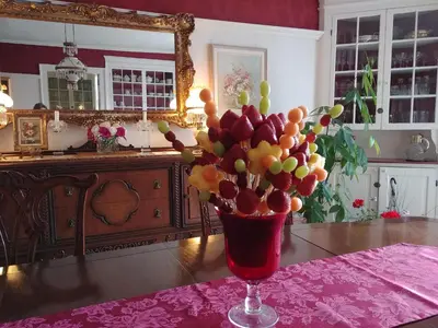 a vase filled with fruit on top of a table at Historic Wilson-Guy House in Niagara on the Lake
