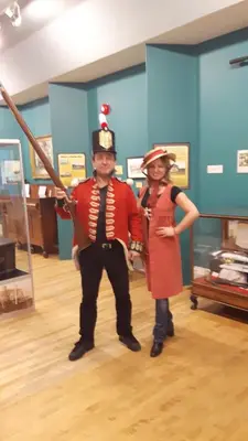 a man and a woman dressed up in costumes at Historic Wilson-Guy House in Niagara on the Lake