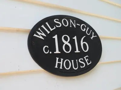 a sign for a willson city house on a building at Historic Wilson-Guy House in Niagara on the Lake