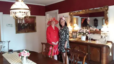 two women standing in front of a mirror at Historic Wilson-Guy House in Niagara on the Lake