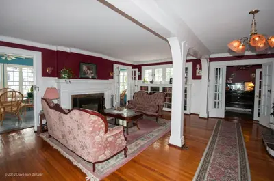 a living room with a couch and a fireplace at Chestnut Inn in Niagara Falls