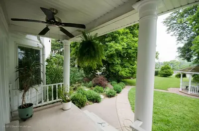 a porch with a ceiling fan on a house at Chestnut Inn in Niagara Falls
