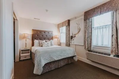 a bedroom with a large bed and a window at Moffat Inn in Niagara on the Lake