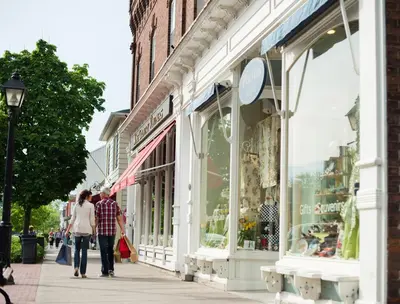people walking down a sidewalk in front of a store at Moffat Inn in Niagara on the Lake