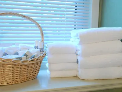 a basket of towels sitting next to a pile of towels at Moffat Inn in Niagara on the Lake