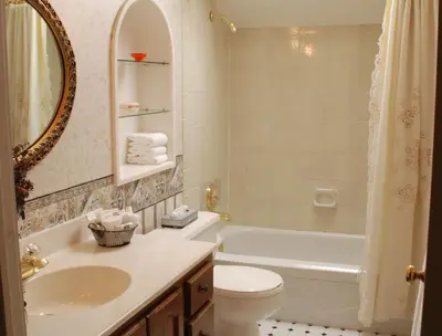 a bathroom with a sink and a toilet and a tub at Moffat Inn in Niagara on the Lake