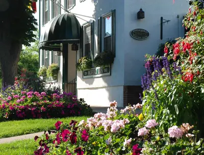 a house with flowers in front of it at Moffat Inn in Niagara on the Lake