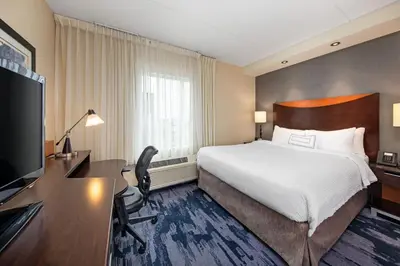a hotel room with a bed and a desk and a computer at Fairfield Inn & Suites by Marriott Toronto Mississauga in Mississauga