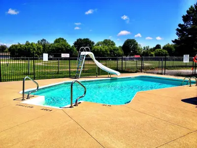 a small swimming pool with a slide in a fence at Angus Inn Motel in Angus