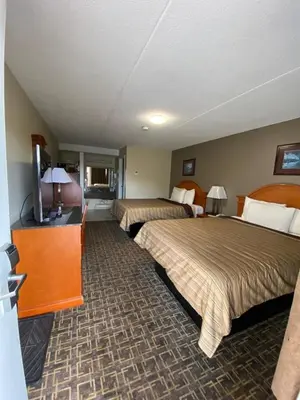 a hotel room with two beds and a flat screen tv at Angus Inn Motel in Angus