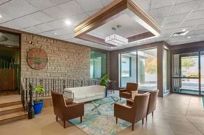 a lobby with a couch and chairs in a building at Quality Inn & Conference Centre in Midland