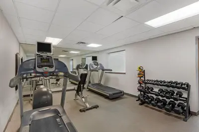 a gym with two tread machines and a treadmill at Quality Inn & Conference Centre in Midland