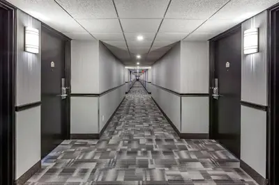 a hallway with a long row of elevators in a building at Quality Inn & Conference Centre in Midland