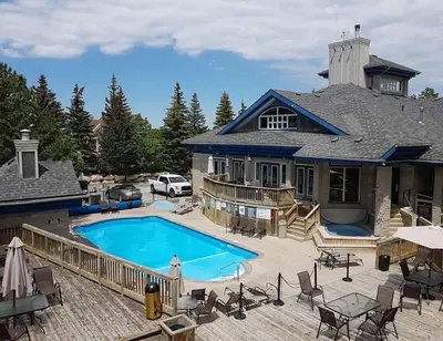 an aerial view of a house with a swimming pool at Rustic Mountainside Chalet in Blue Mountains
