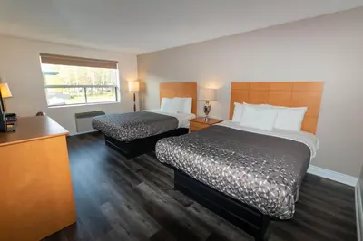 a hotel room with two beds and a window at Borden Inn and Suites in Angus