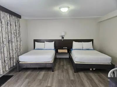 a room with two beds and a window at Leelas Villa Inn Flesherton in Flesherton