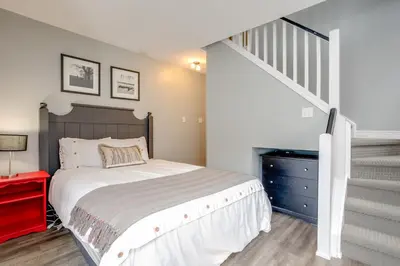 a bedroom with a large bed and a staircase at Blue Mountain Studio Loft at North Creek Resort in Blue Mountains