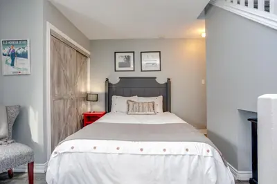 a bedroom with a large bed and a chair at Blue Mountain Studio Loft at North Creek Resort in Blue Mountains