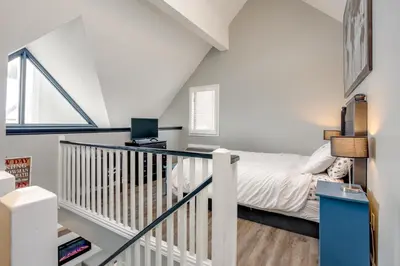 a white bedroom with a bed and a window at Blue Mountain Studio Loft at North Creek Resort in Blue Mountains