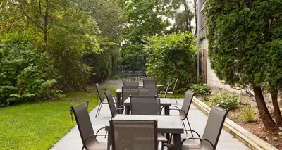 a row of tables and chairs in a garden at Elm Hurst Inn & Spa in Ingersoll