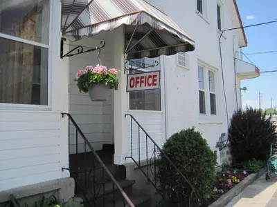 a office sign on the door of a house at Rosecourt Motel in Stratford