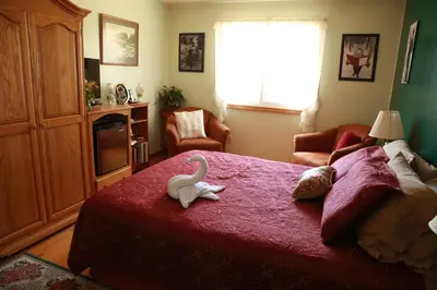 a bedroom with a bed with two stuffed animals on it at A Garden Stroll Bed & Breakfast in Stratford