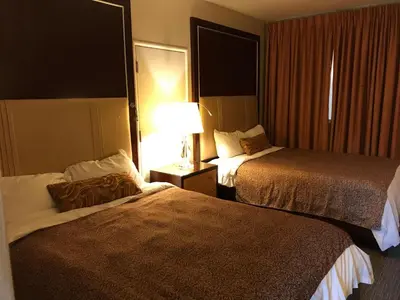 a hotel room with two beds and a lamp at Cardinal Court Motel in Saint Thomas