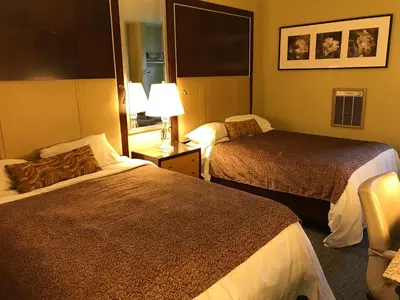 a hotel room with two beds and a lamp at Cardinal Court Motel in Saint Thomas