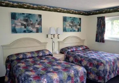 a hotel room with two beds and a window at Stratford Suburban Motel in Stratford