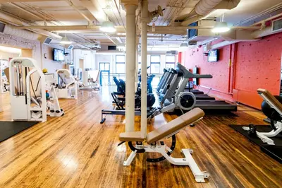 a gym with treadmills and machines in a room at The Ivy at Verity in Toronto