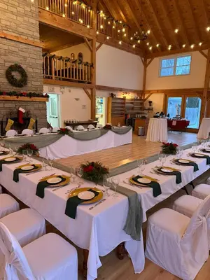 a banquet hall with white tables and white chairs at Timber House Resort in Brighton