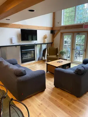 a living room with two couches and a fireplace at Timber House Resort in Brighton