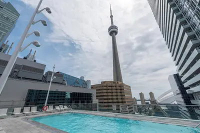 a swimming pool with the cn tower in the background at Luxury condo on CN TOWER in Toronto