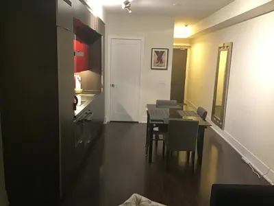 a kitchen and dining room with a table and chairs at Luxury condo on CN TOWER in Toronto