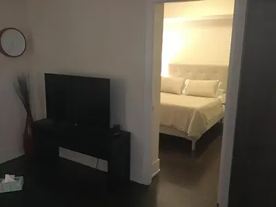 a bedroom with a bed and a flat screen tv at Luxury condo on CN TOWER in Toronto